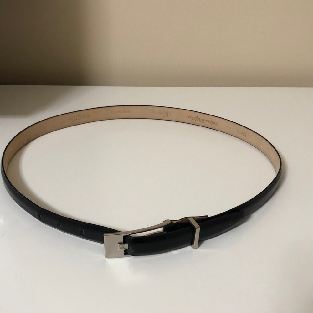 Calvin Klein black leather belt. 30 inches long. Silver buckle